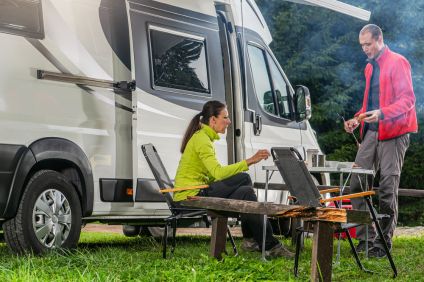A couple in the camping ground with their RV park